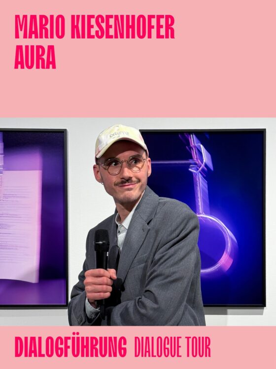 Mario Kiesenhofer speaking during the AURA dialogue tour event, with vibrant background visuals.