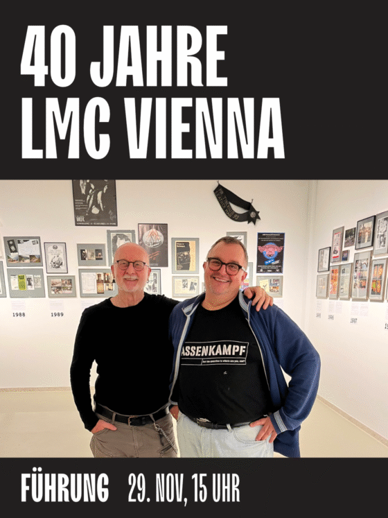 Zwei Personen posieren vor einer Ausstellung zum 40-jährigen Jubiläum von LMC Vienna.